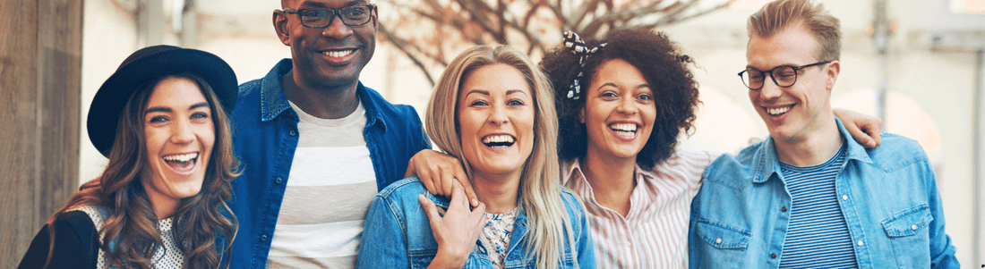 Group of happy friends enjoying life while showcasing herbal skincare products for radiant skin and healthy hair
